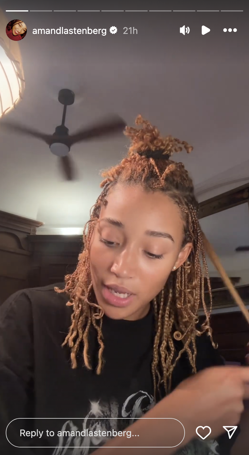 Amandla Stenberg is styling their hair in a close-up selfie video