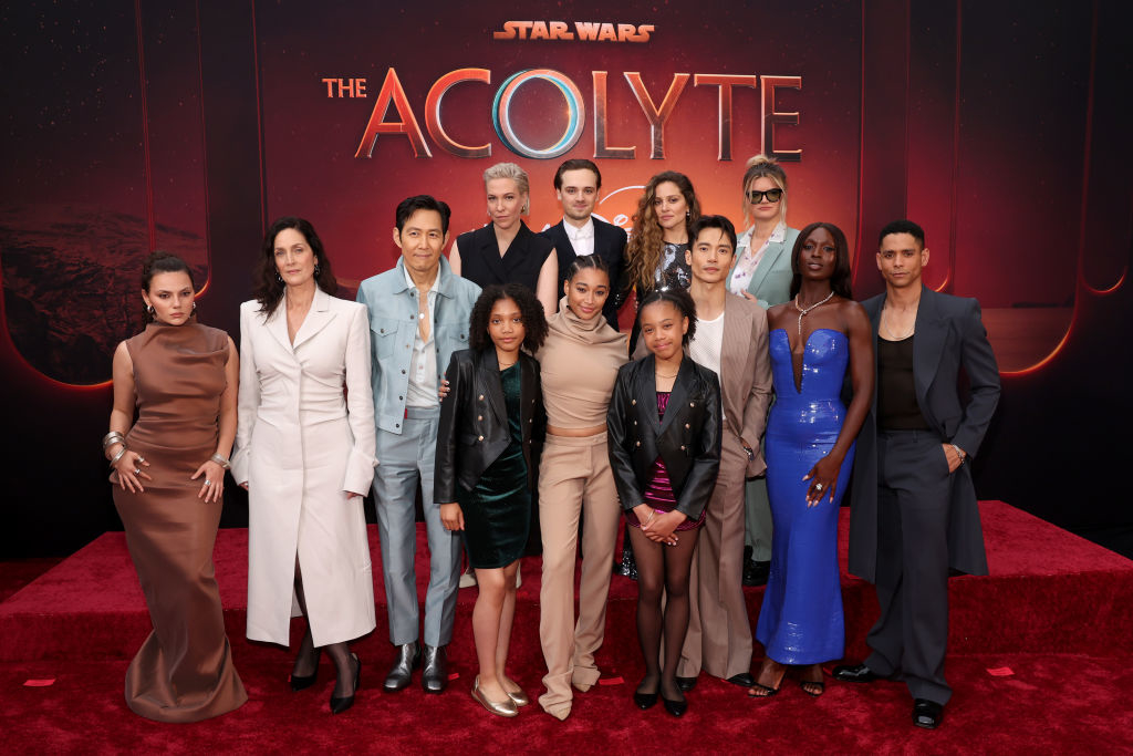 Cast of "Star Wars: The Acolyte" posing on the red carpet, featuring various actors in stylish attire
