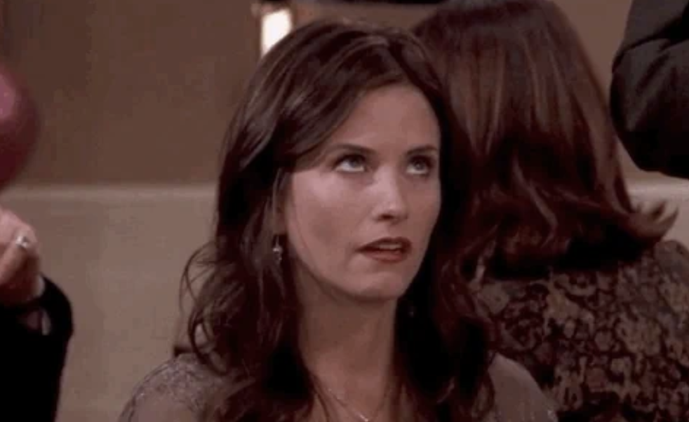 Courteney Cox rolls her eyes in an exasperated expression in a scene from a TV show
