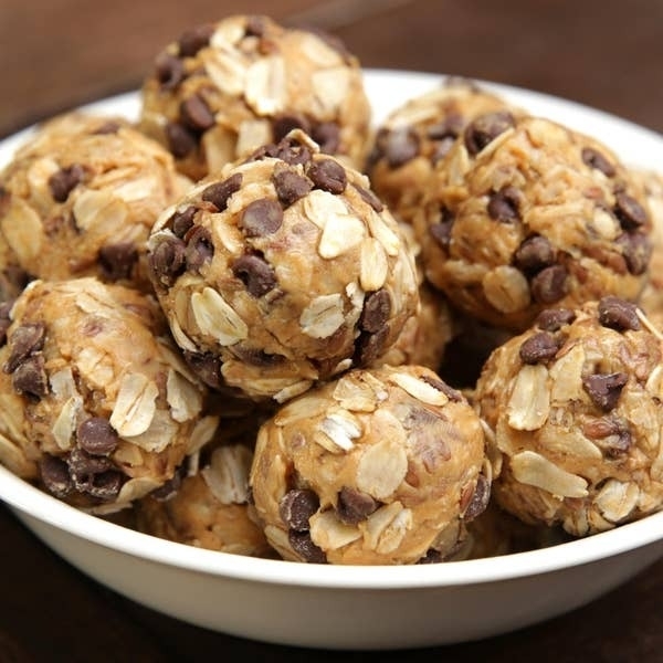A bowl filled with several oatmeal and chocolate chip energy bites