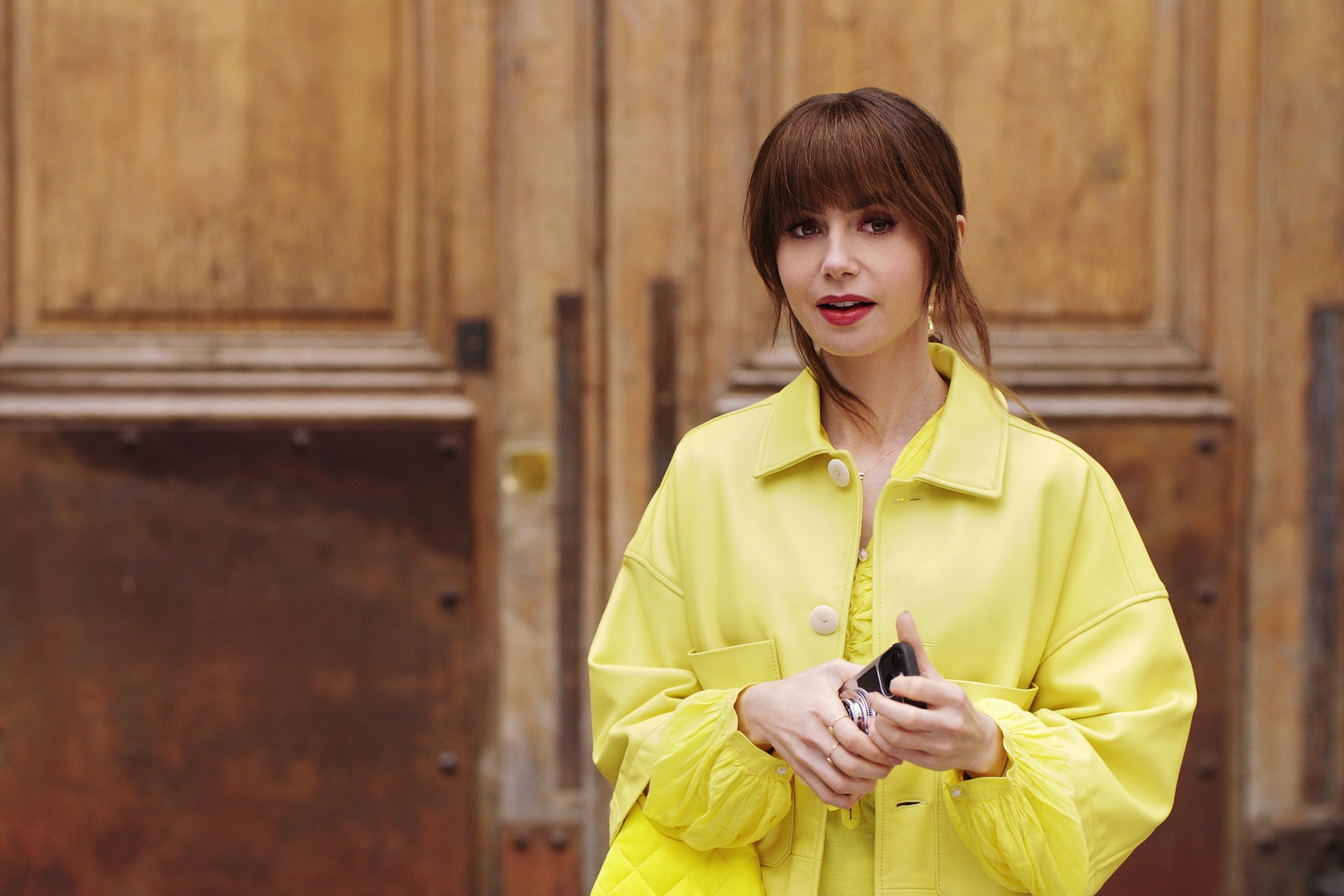 Lily Collins in a yellow outfit in "Emily in Paris."