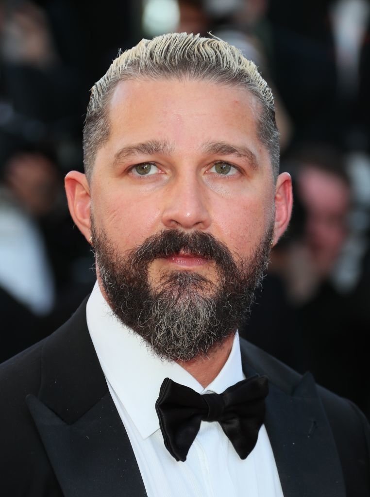 Shia LaBeouf on the red carpet wearing a black tuxedo with a bow tie