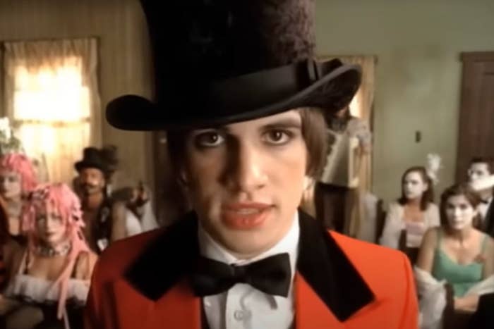 Brendon Urie wearing a suit and top hat in Panic at the Disco's I Write Sins Not Tragedies music video