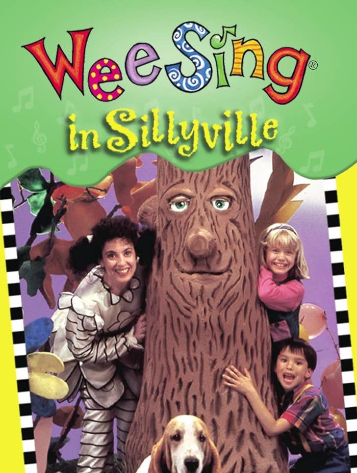 Cover of "Wee Sing in Sillyville" featuring two children, an adult in a whimsical costume, a tree character, and a dog