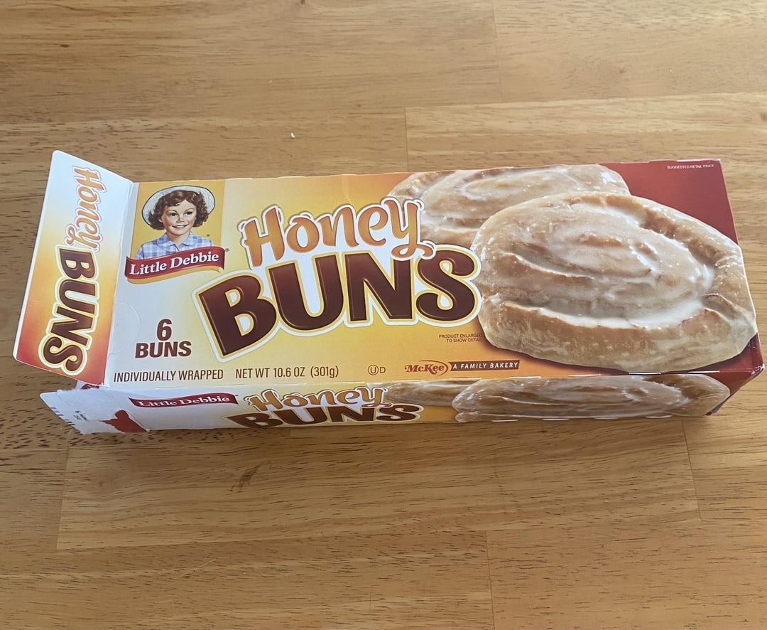 Little Debbie Honey Buns package is displayed on a wooden table