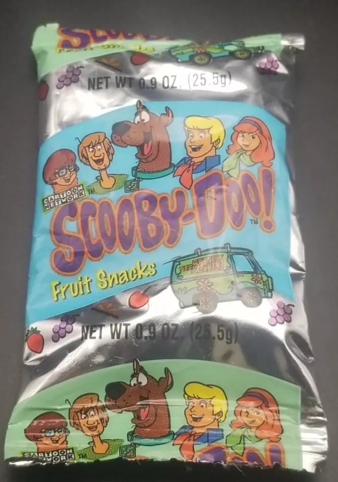 A package of Scooby-Doo fruit snacks featuring cartoon characters Scooby-Doo, Shaggy, Velma, Fred, and Daphne, along with the Mystery Machine van