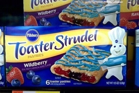 Box of Pillsbury Toaster Strudel Wildberry pastries, featuring an image of a strudel with blue icing and berries, and the Pillsbury Doughboy on the box