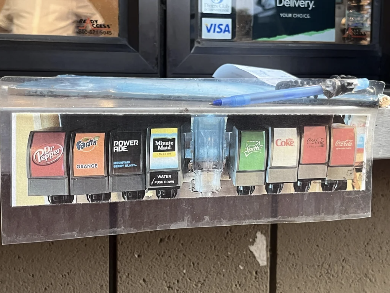 Soft drink dispenser machine showing options for Dr Pepper, Fanta, Powerade, Minute Maid, Sprite, Coke, and Coca-Cola Zero