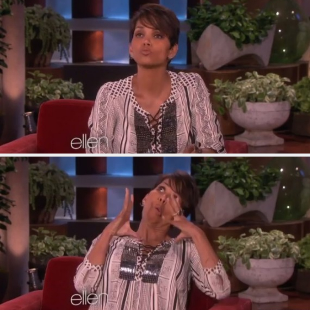 Halle Berry is seated, wearing a patterned top, making humorous and expressive faces during an appearance on "The Ellen DeGeneres Show."