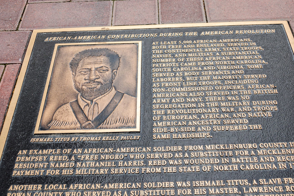 Bronze plaque titled &quot;African-American Contributions During the American Revolution&quot; with a portrait of Ismael Titus and text detailing contributions of African-Americans