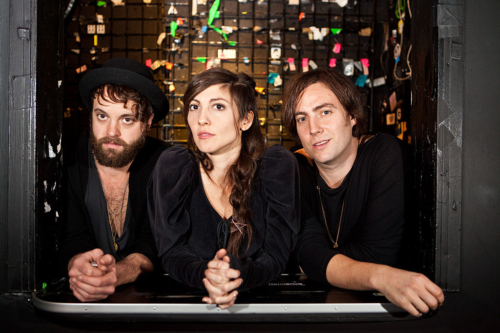 Nico Vega poses against a cluttered backdrop