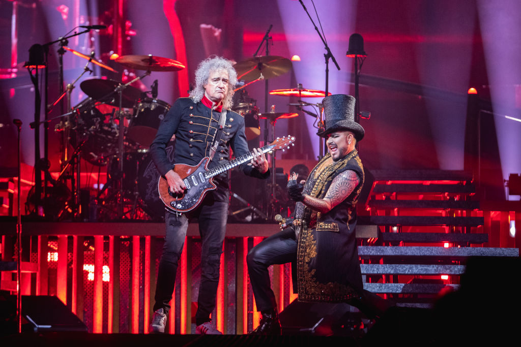 Brian May plays guitar while Adam Lambert performs