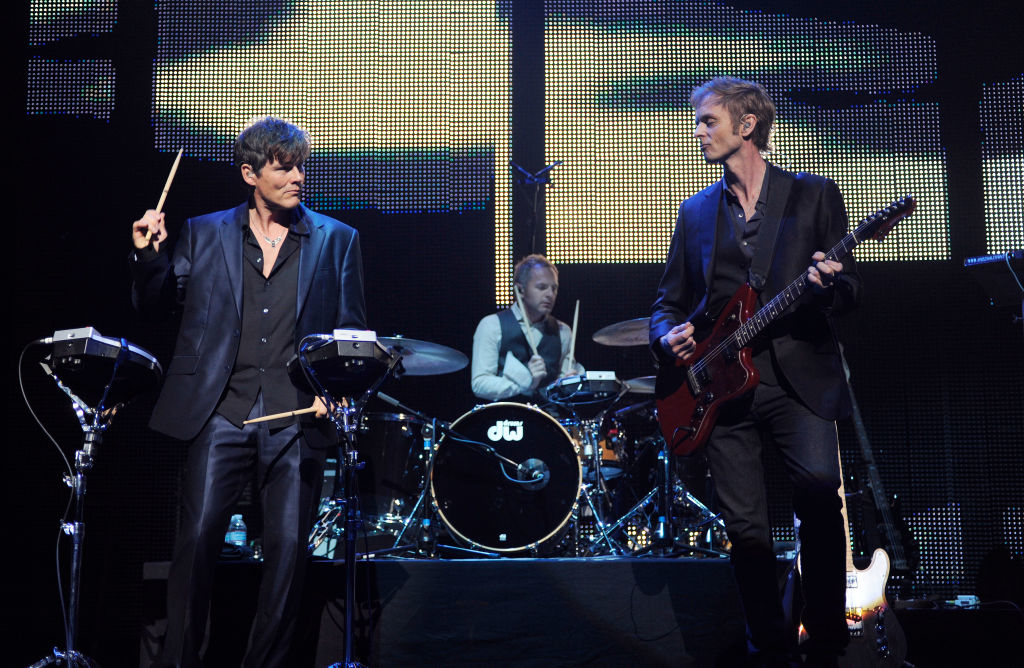 Morten Harket, Magne Furuholmen, and Paul Waaktaar-Savoy of a-ha perform on stage