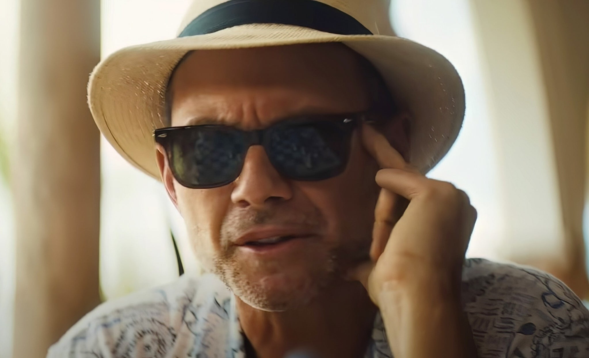 Christian Slater wearing a fedora hat and sunglasses in "Blink Twice"