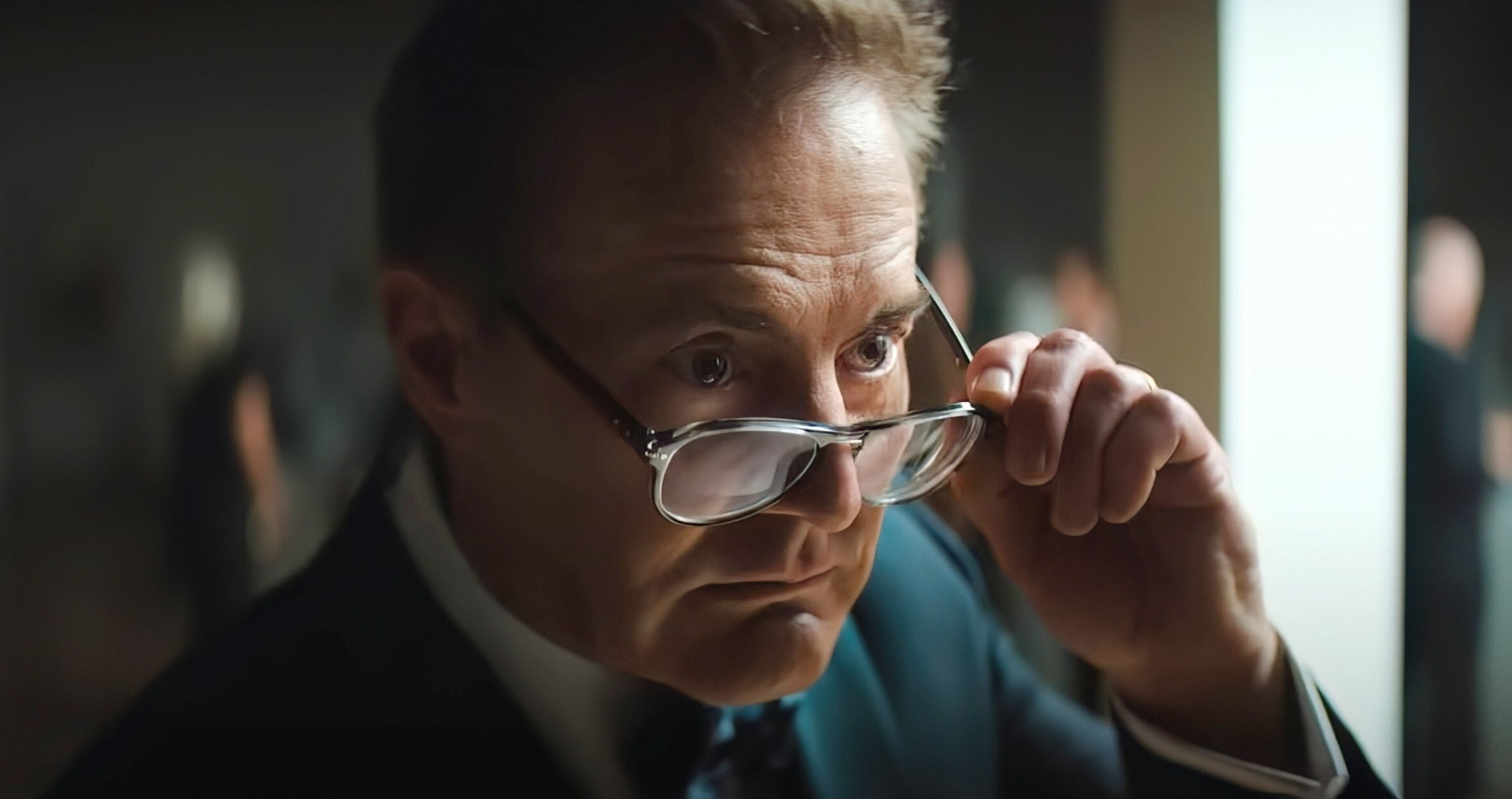 Kyle MacLachlan wearing glasses and a suit in "Blink Twice"