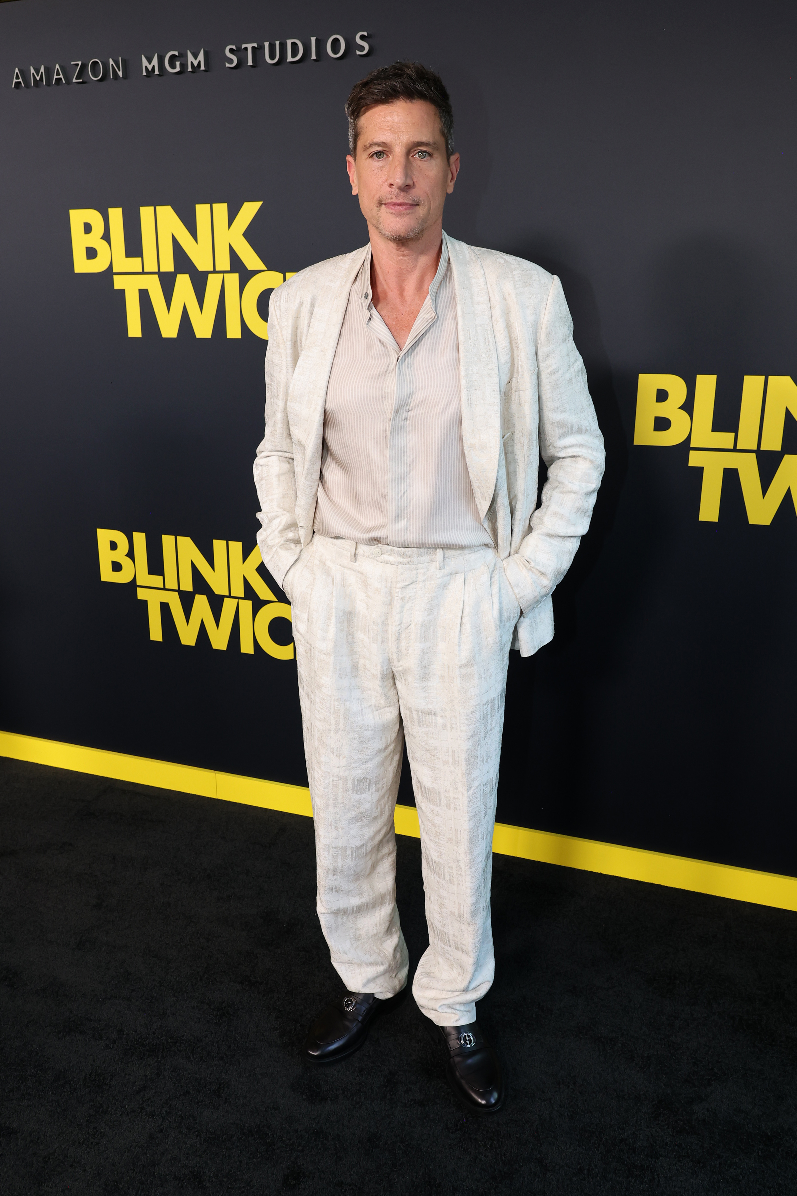 Simon Rex in a white outfit for the premiere of "Blink Twice"