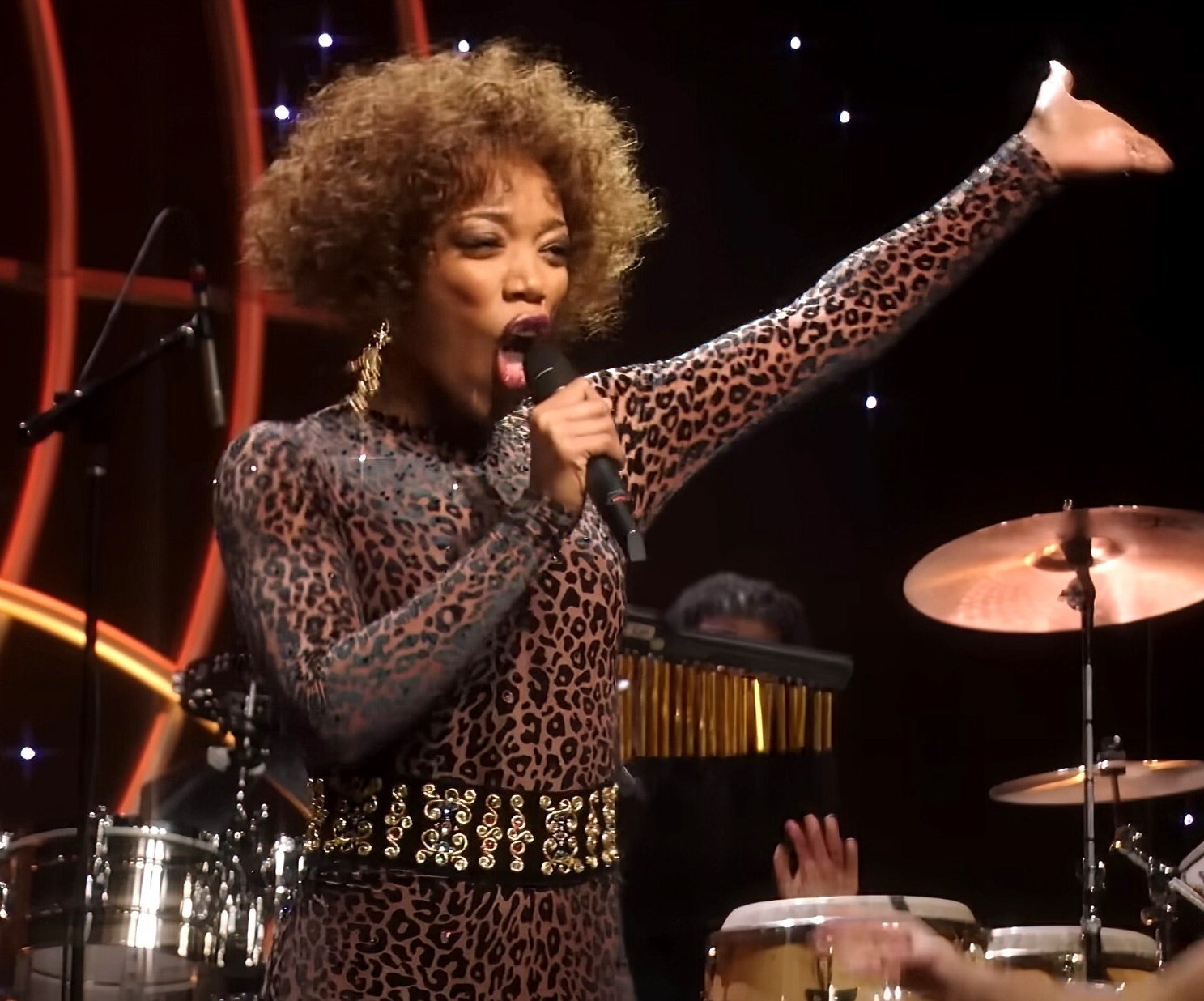 Naomi Ackie performs on stage in a leopard outfit in "Whitney Houston: I Wanna Dance with Somebody"
