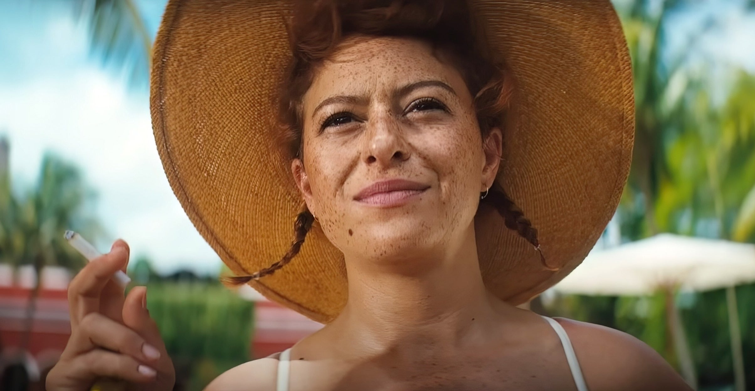 Alia Shawkat wearing a hat with her hair in braids in "Blink Twice"