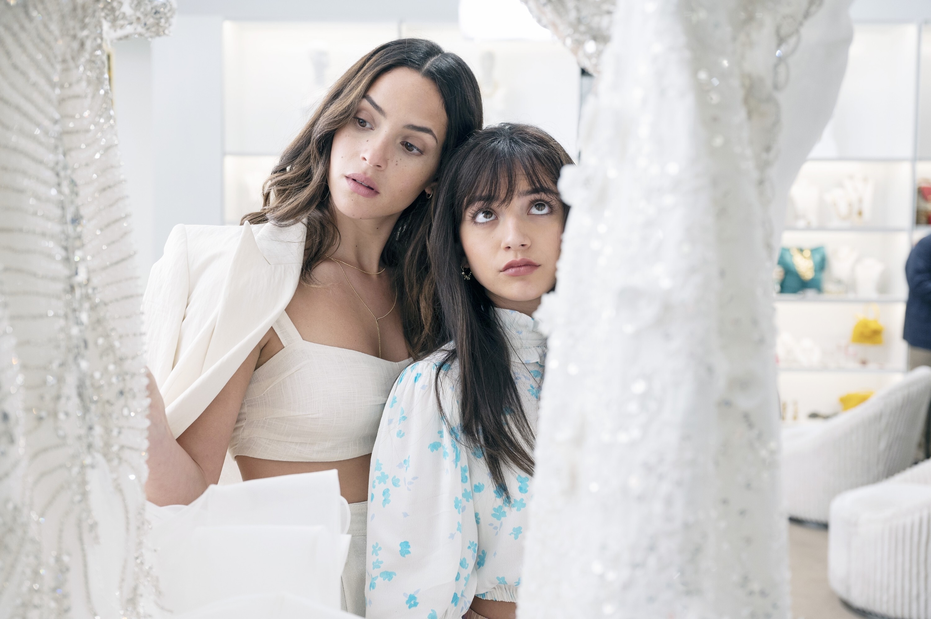 Adria Arjona and Isabela Merced browse wedding dresses in a boutique in "Father of the Bride"