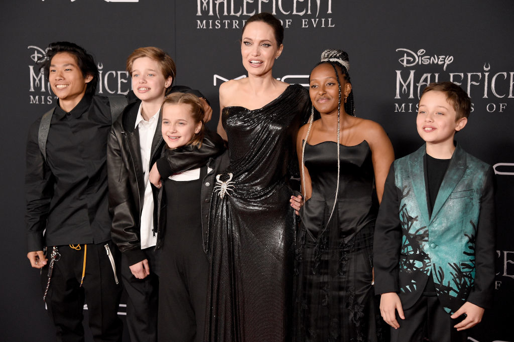 Angelina Jolie in a shimmering gown with her children Pax, Shiloh, Vivienne, Zahara, and Knox at the "Maleficent: Mistress of Evil" premiere