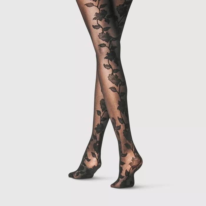 Close-up of legs successful achromatic floral-patterned tights from the waist down