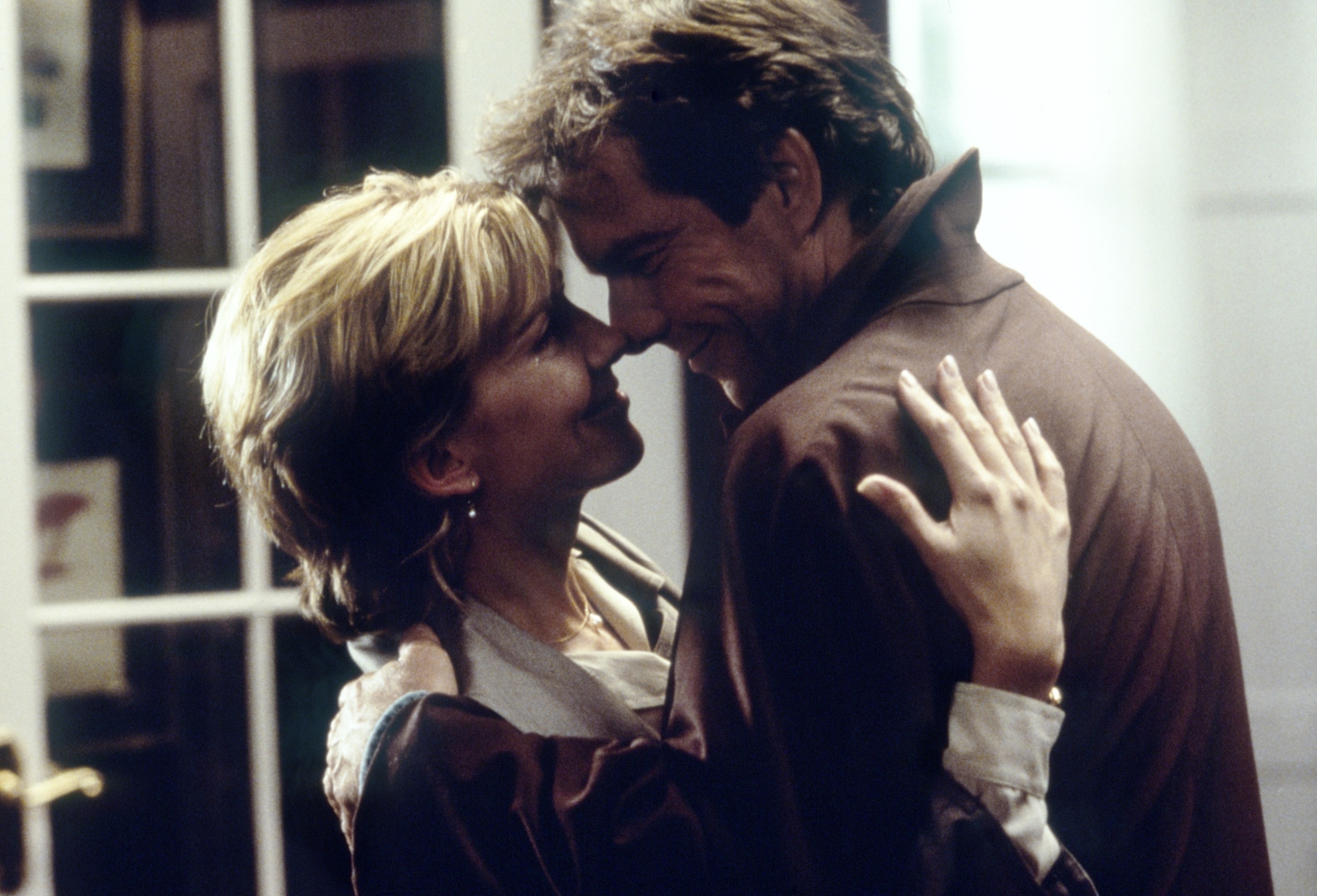 Natasha Richardson and Dennis Quaid embracing and smiling at each other in a scene from a movie