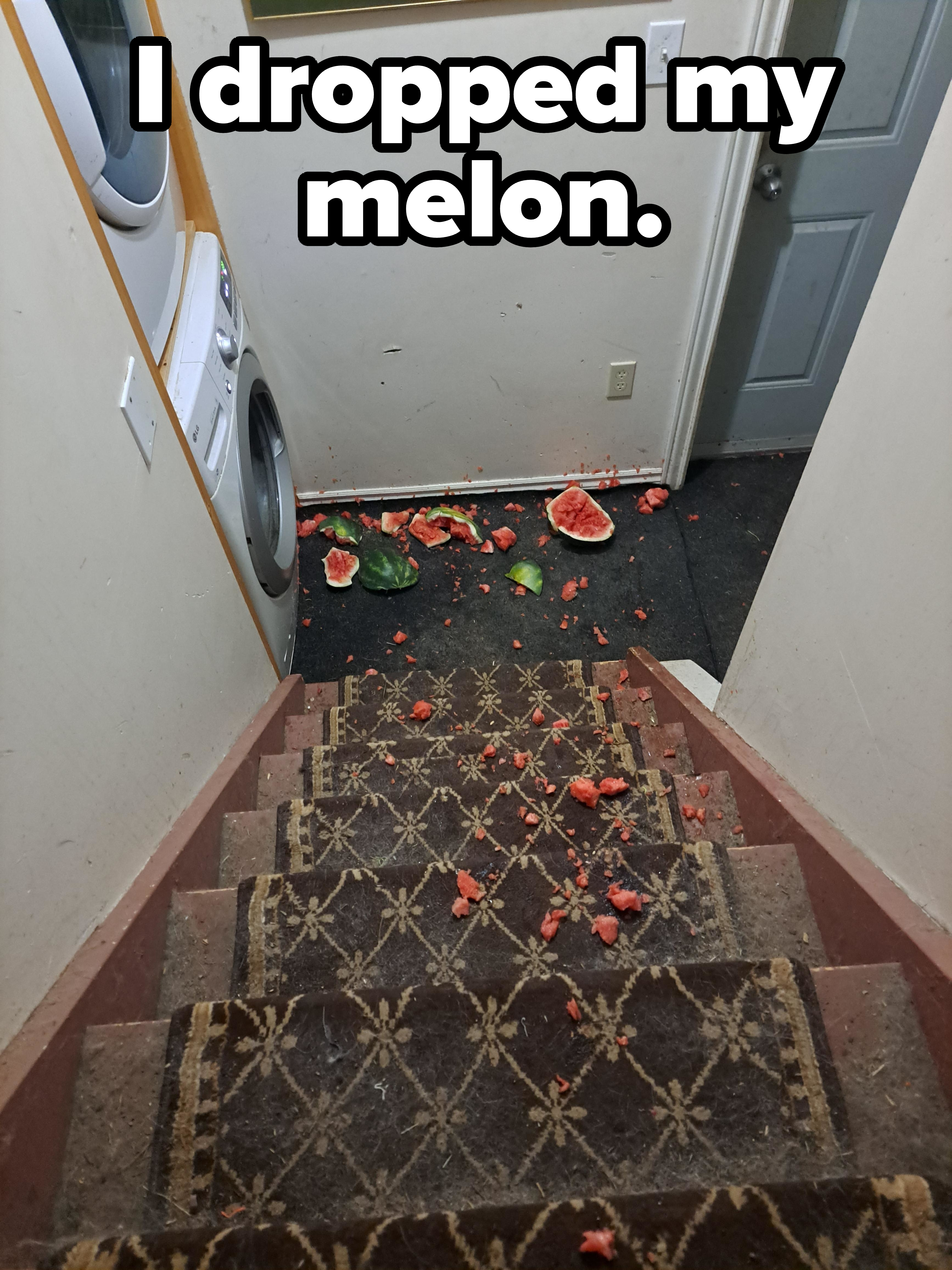 A staircase leading to a laundry area with a smashed watermelon scattered on the floor and stairs