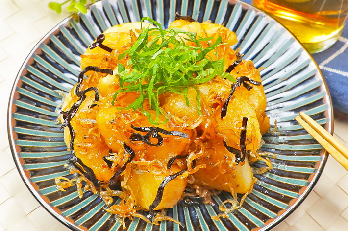陶器の皿に盛られたポテト料理。トッピングには細切りの海苔とみじん切りのネギが載っている。