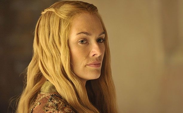 Lena Headey as Cersei Lannister gazes sideways, wearing medieval-inspired attire with intricate designs