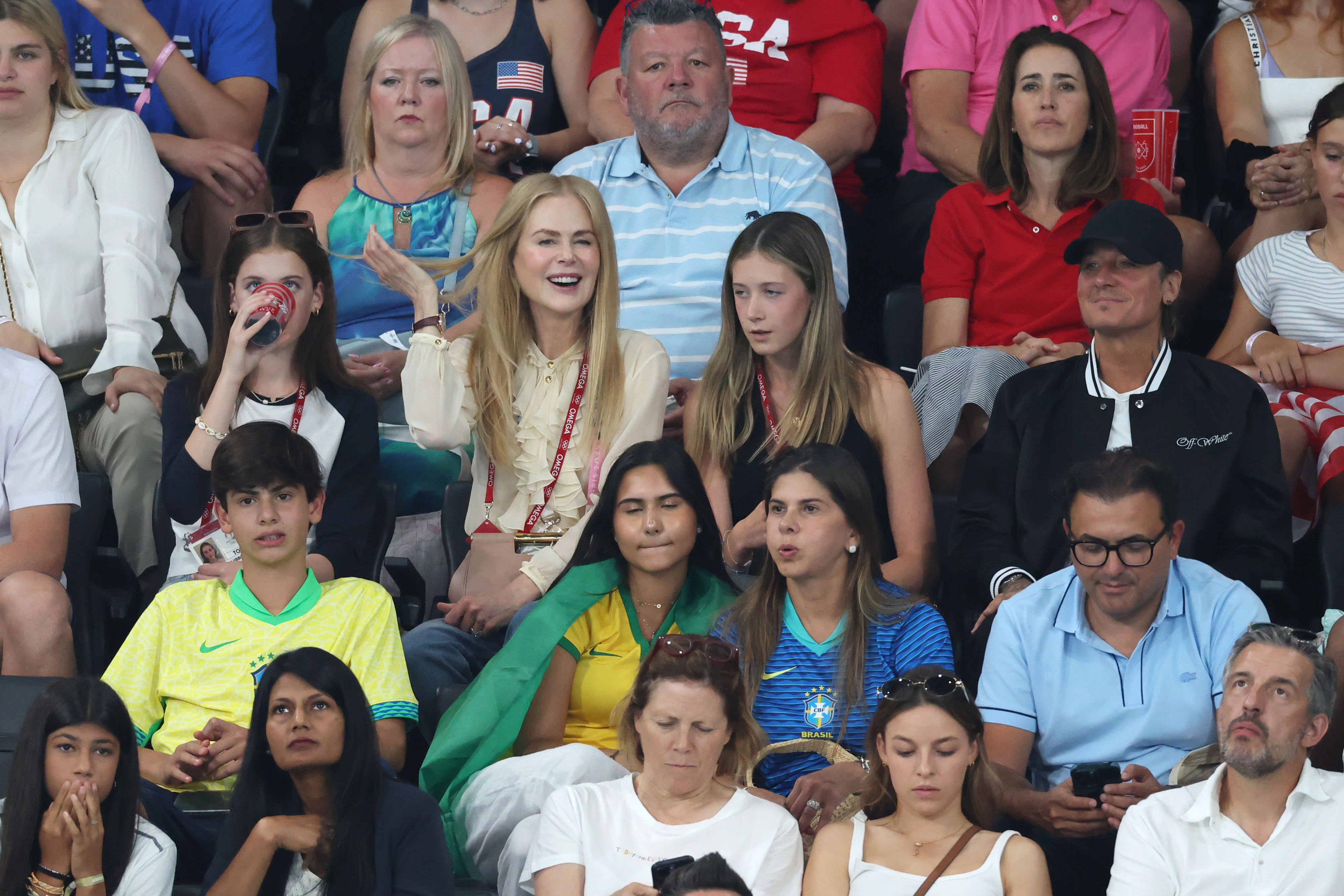 Nicole Kidman with fans in a crowded sports event audience