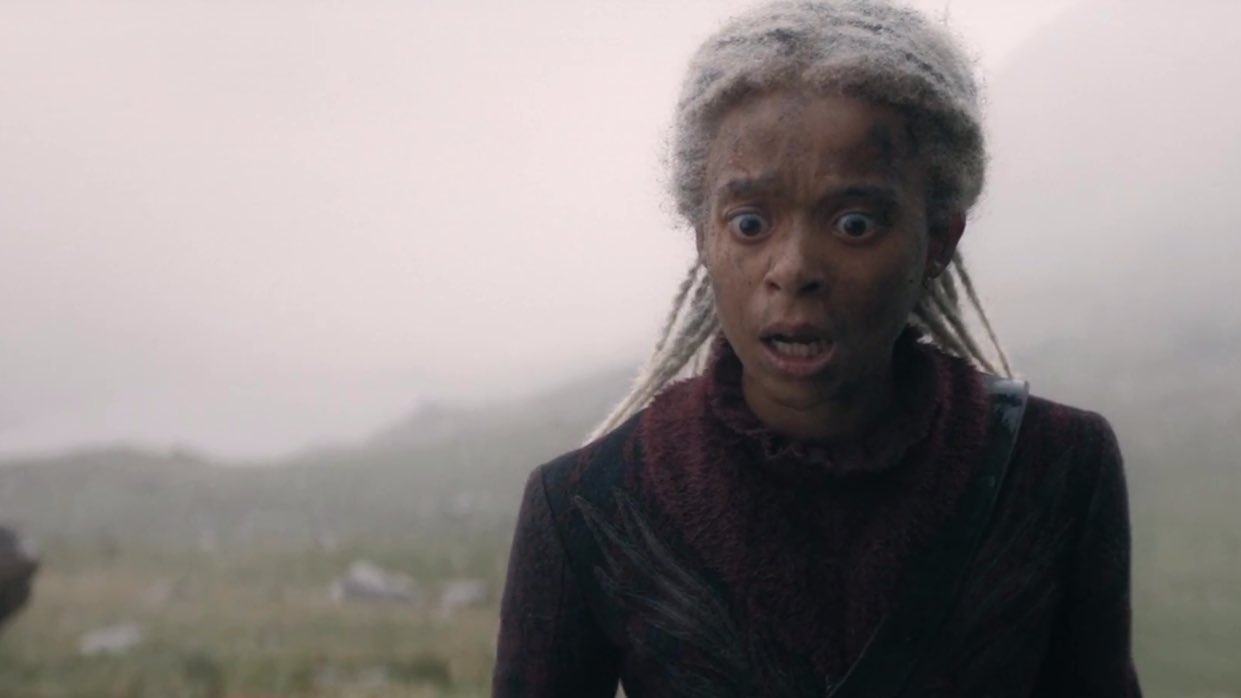 Mujer joven con trenzas largas y expresión de sorpresa, vestida con ropa de estilo medieval