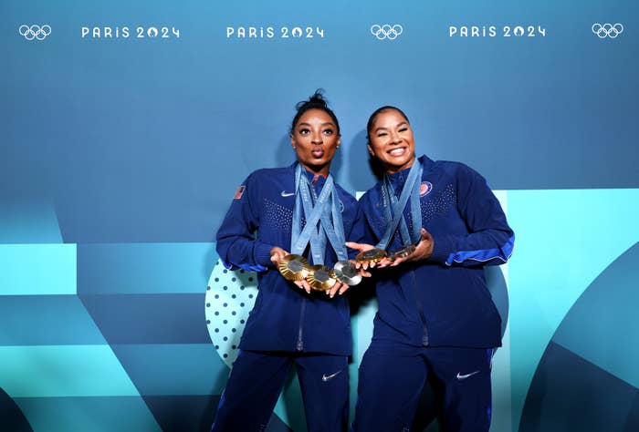 Simone Biles and Jordan Chiles pose with their medals in Team USA tracksuits at the Paris 2024 Olympics