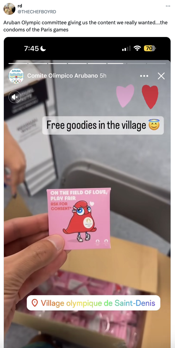 The image shows a social media post from @THECHEFBOYD featuring the Comité Olímpico Arubano distributing condoms at the Paris Games. The caption reads: &quot;Aruban Olympic committee giving us the content we really wanted&hellip;the condoms of the Paris games.&quot;