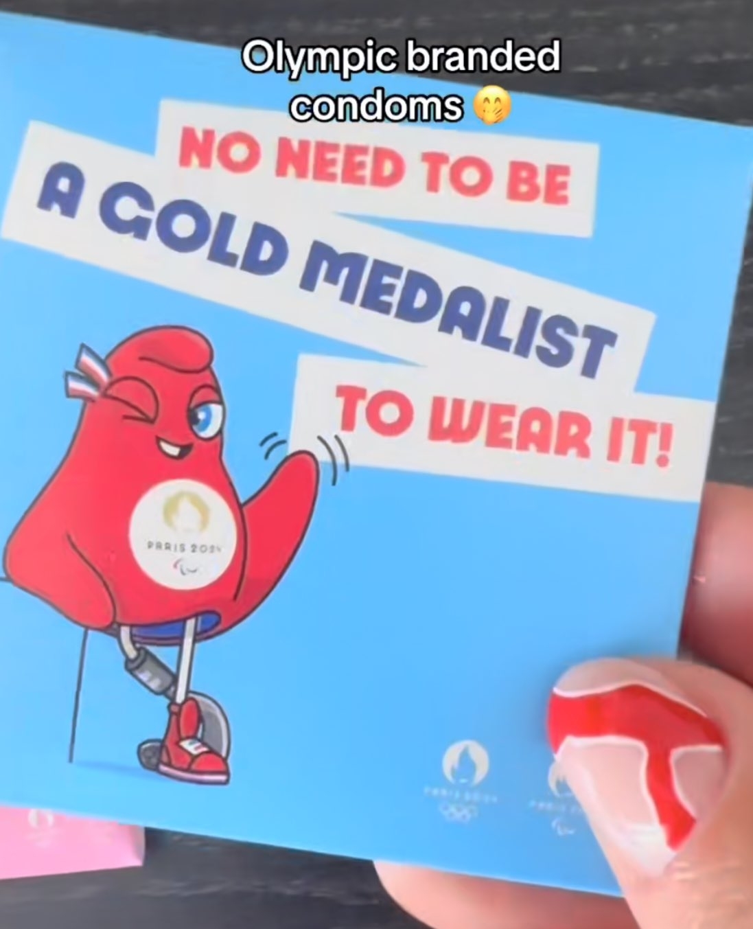 A cartoon Olympic mascot holding a condom with the text: &quot;No need to be a gold medalist to wear it!&quot; Above is text: &quot;Olympic branded condoms.&quot;