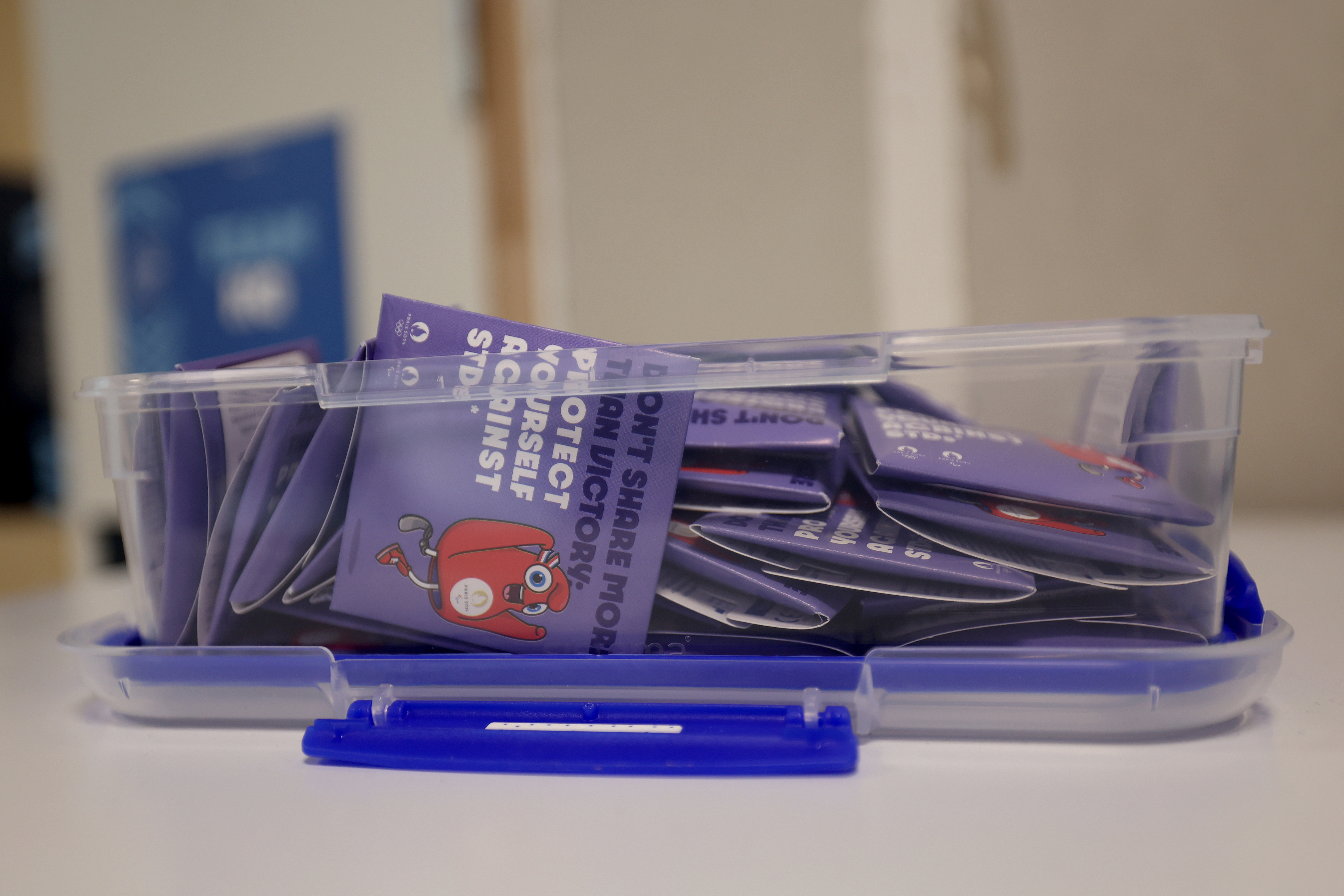 A transparent blue plastic container is filled with purple pins advocating for the protection of personal information