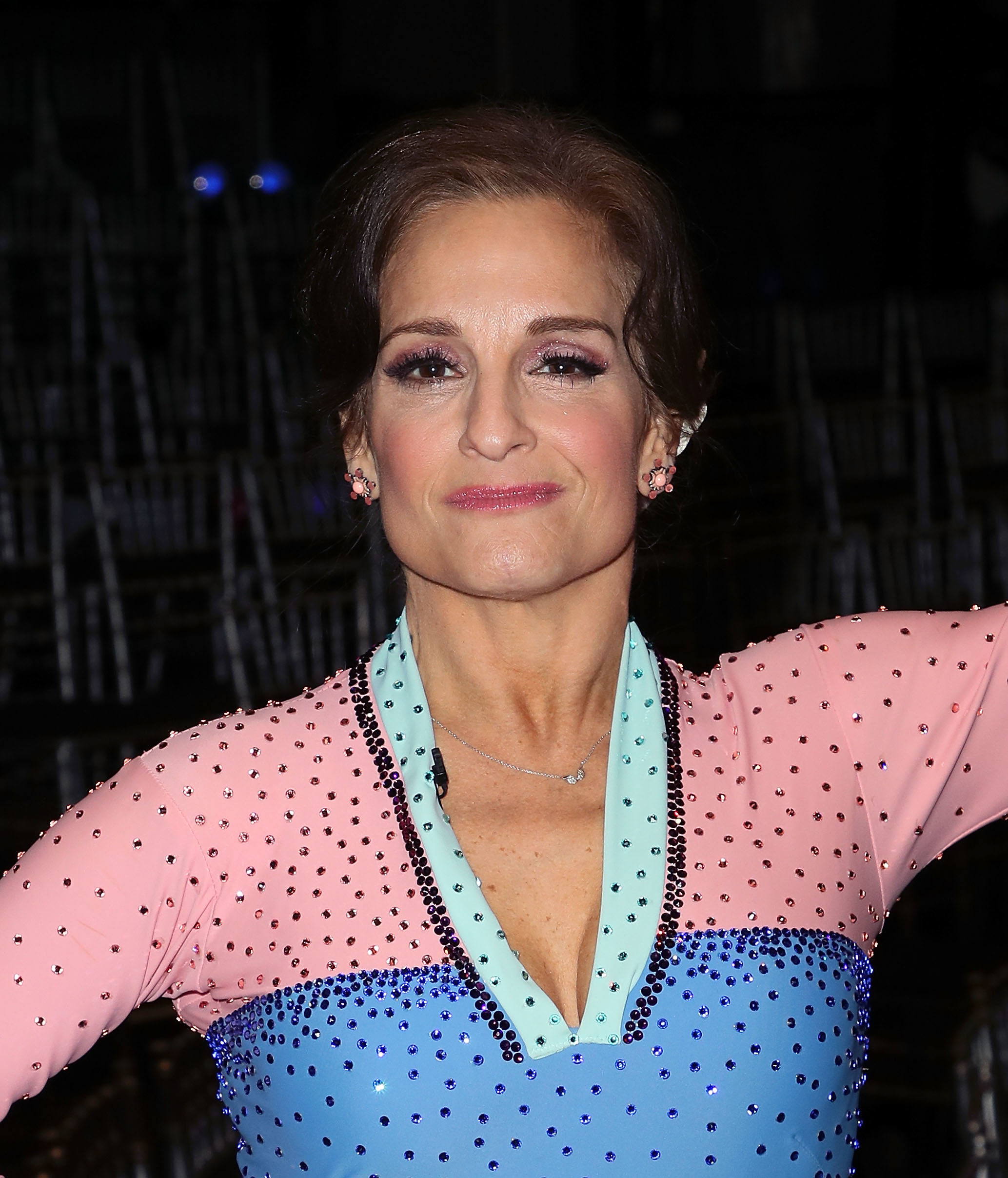 Mary Lou Retton wearing a sparkling dress with rhinestones and smiling