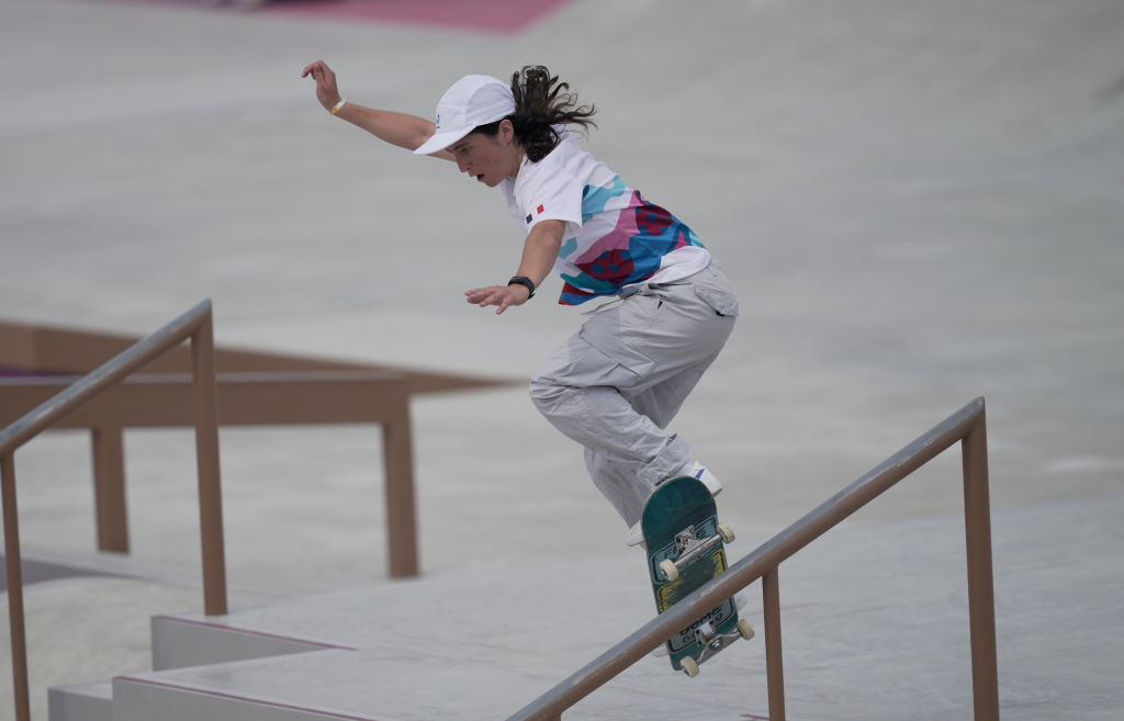 Charlotte performs a trick on a handrail