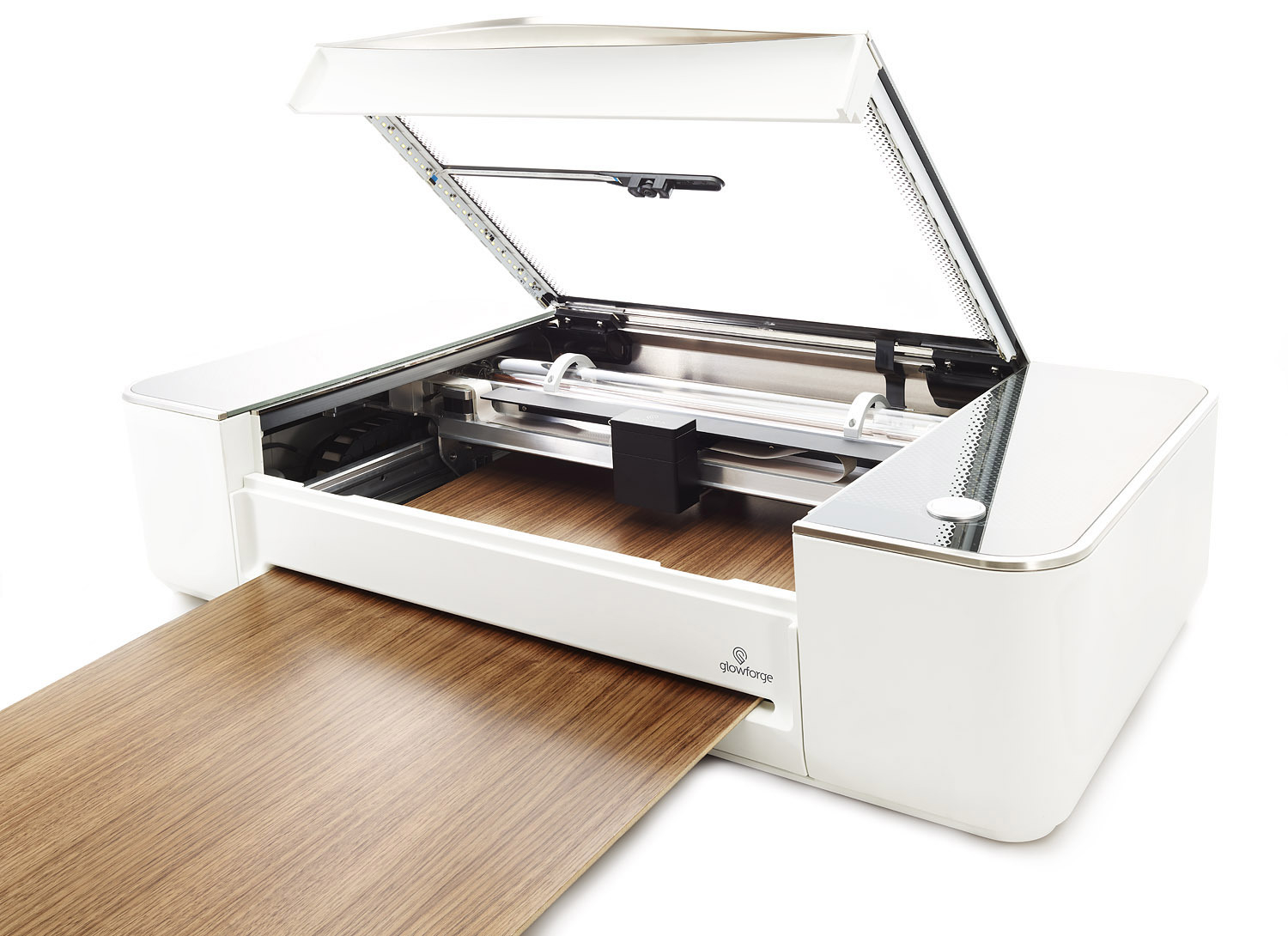A laser cutting machine with its top open, showing a piece of wood partially inserted for cutting