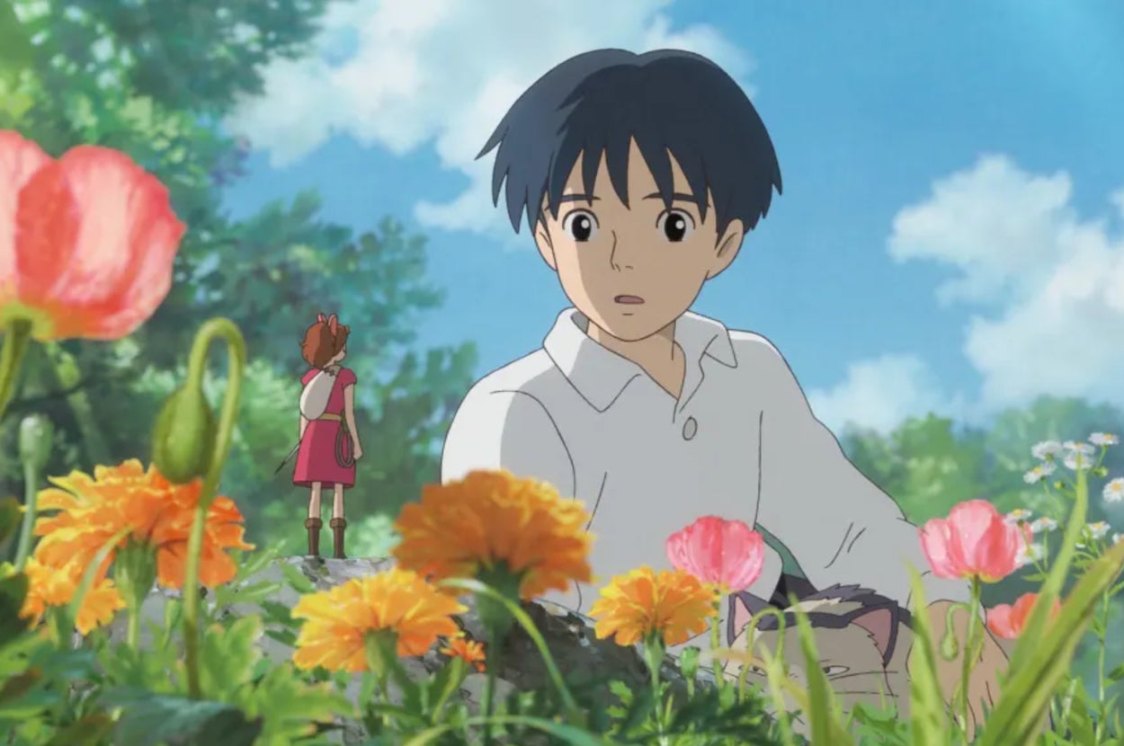 Animated scene with Arrietty and Sho from The Secret World of Arrietty. Arrietty, a tiny girl, stands on a rock near colorful flowers while Sho looks at her in surprise