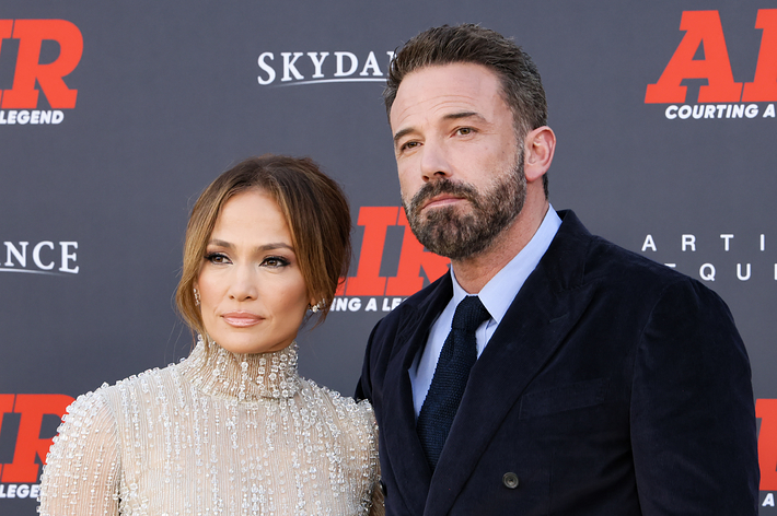 Jennifer Lopez in a beaded high-neck dress and Ben Affleck in a dark suit on the red carpet at the premiere of "Air: Courting a Legend."