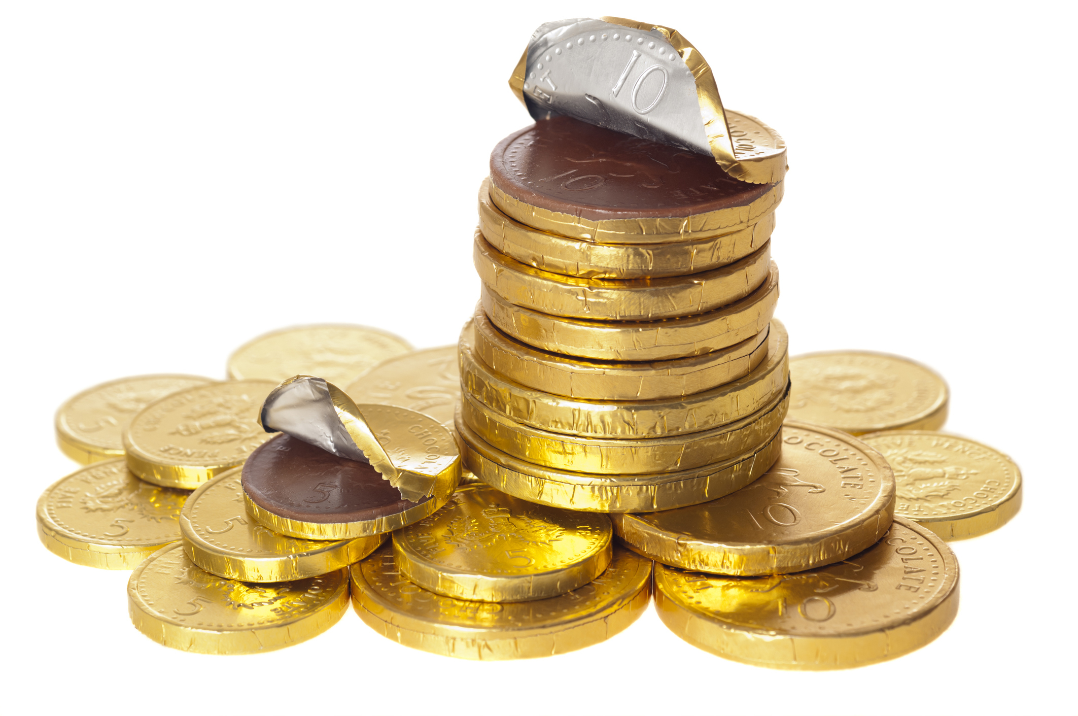 Stacks of gold foil-wrapped chocolate coins, with tops partially unwrapped to reveal chocolate inside