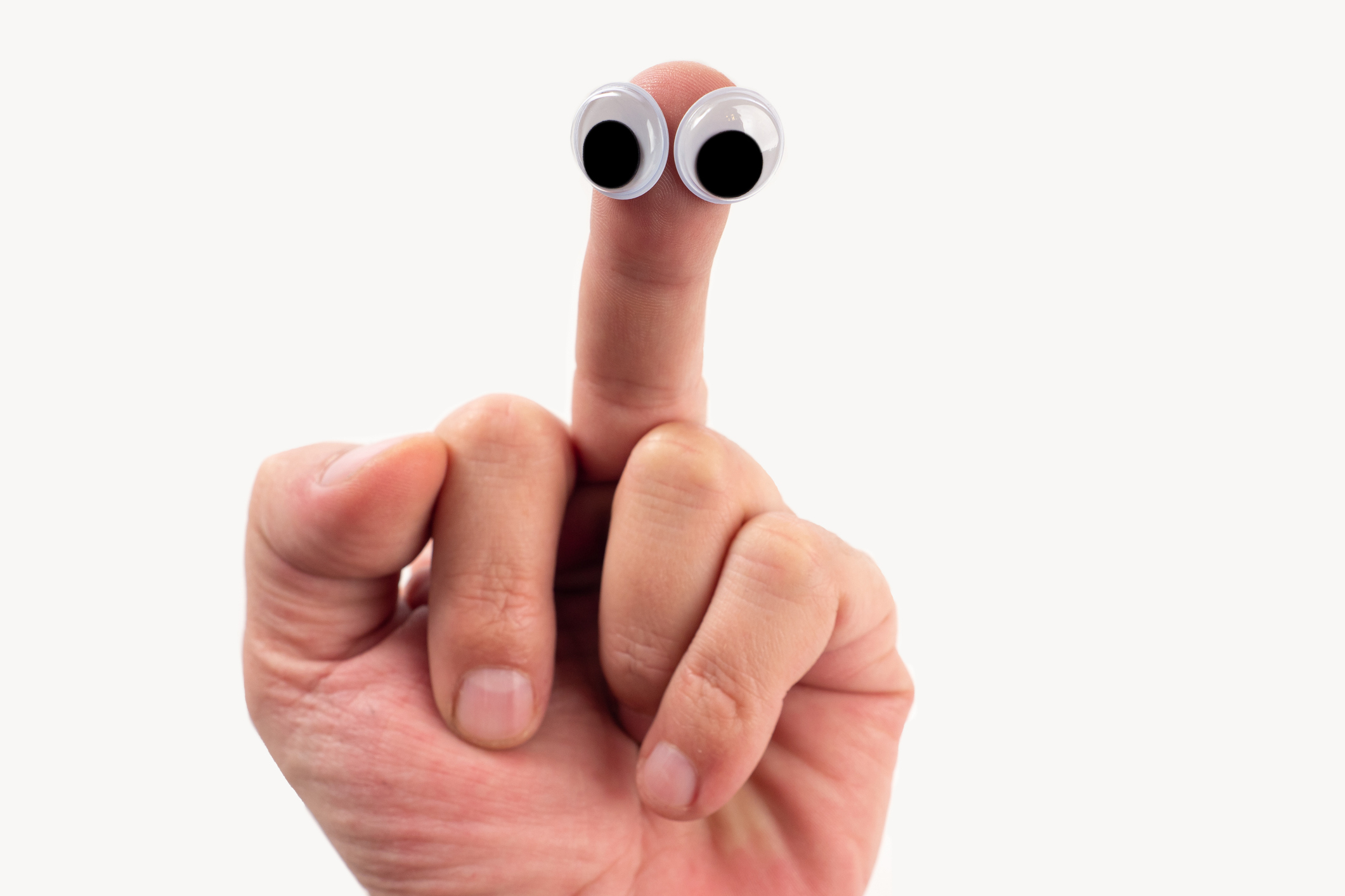 A hand holding up an index finger with two googly eyes attached to it, creating the appearance of a small face