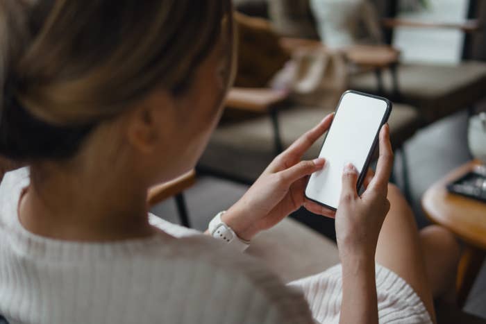 Person holding and looking at a smartphone