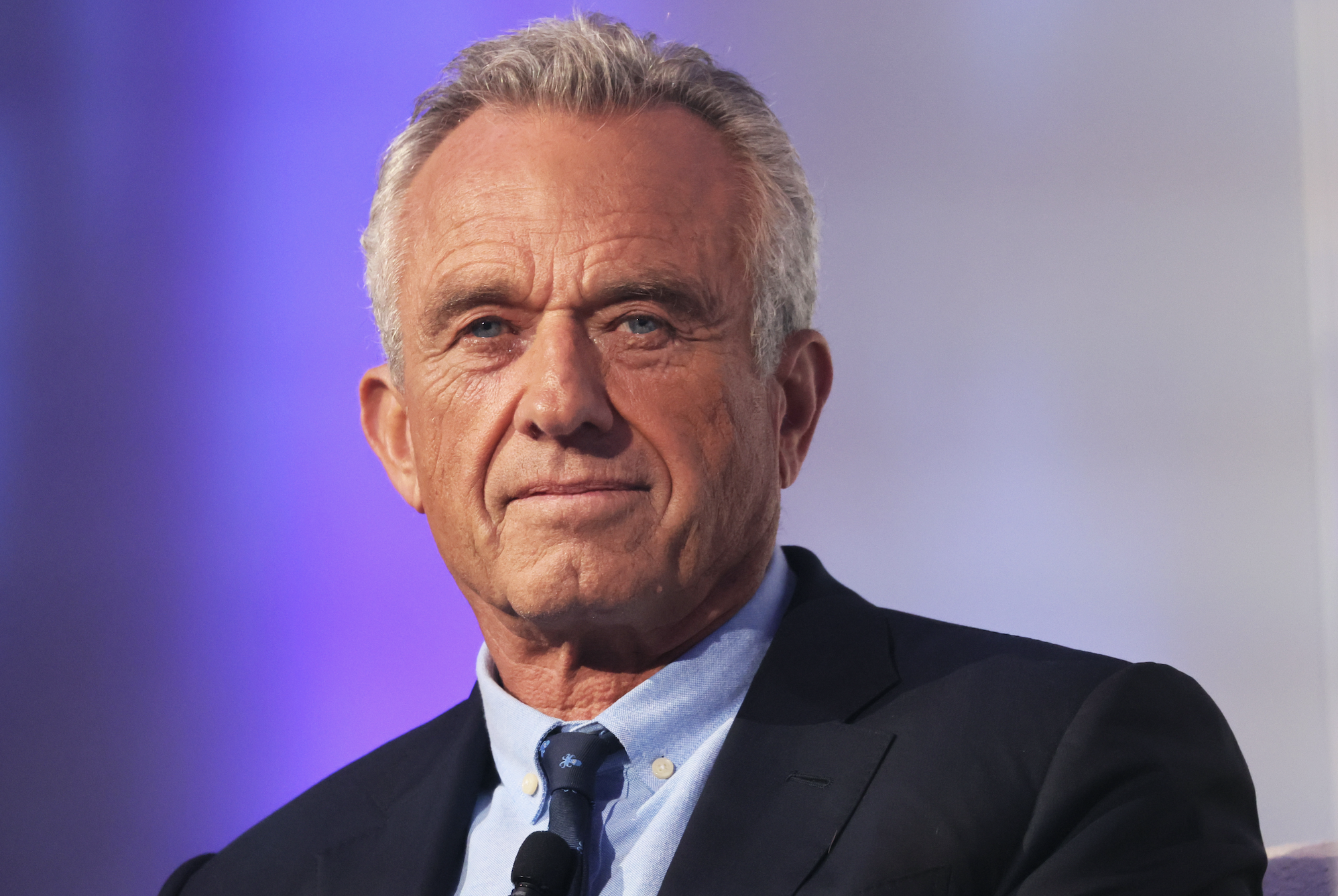 Robert F. Kennedy Jr. in a suit and tie, looking forward during an event