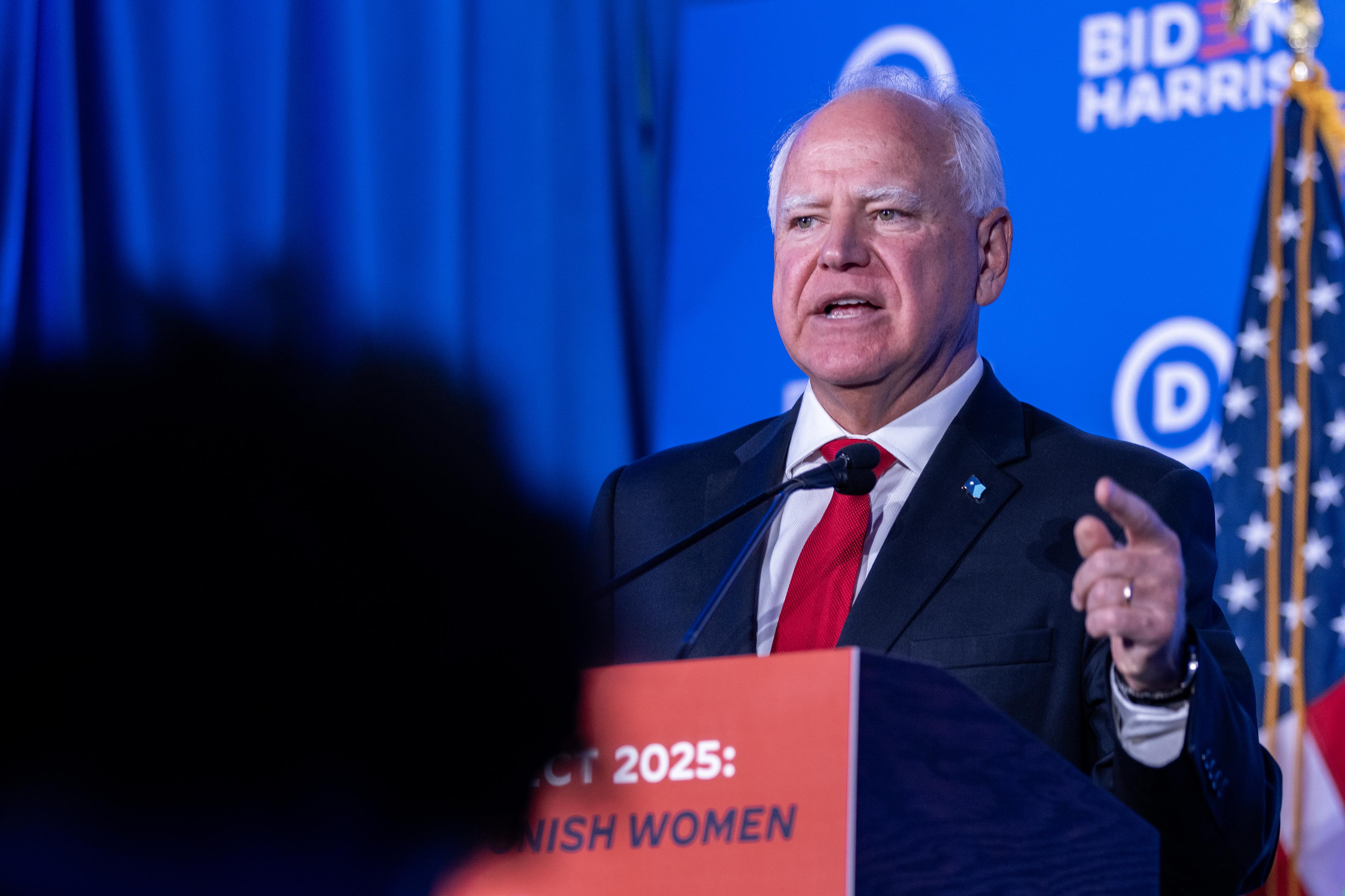 Tim Walz speaking at a podium