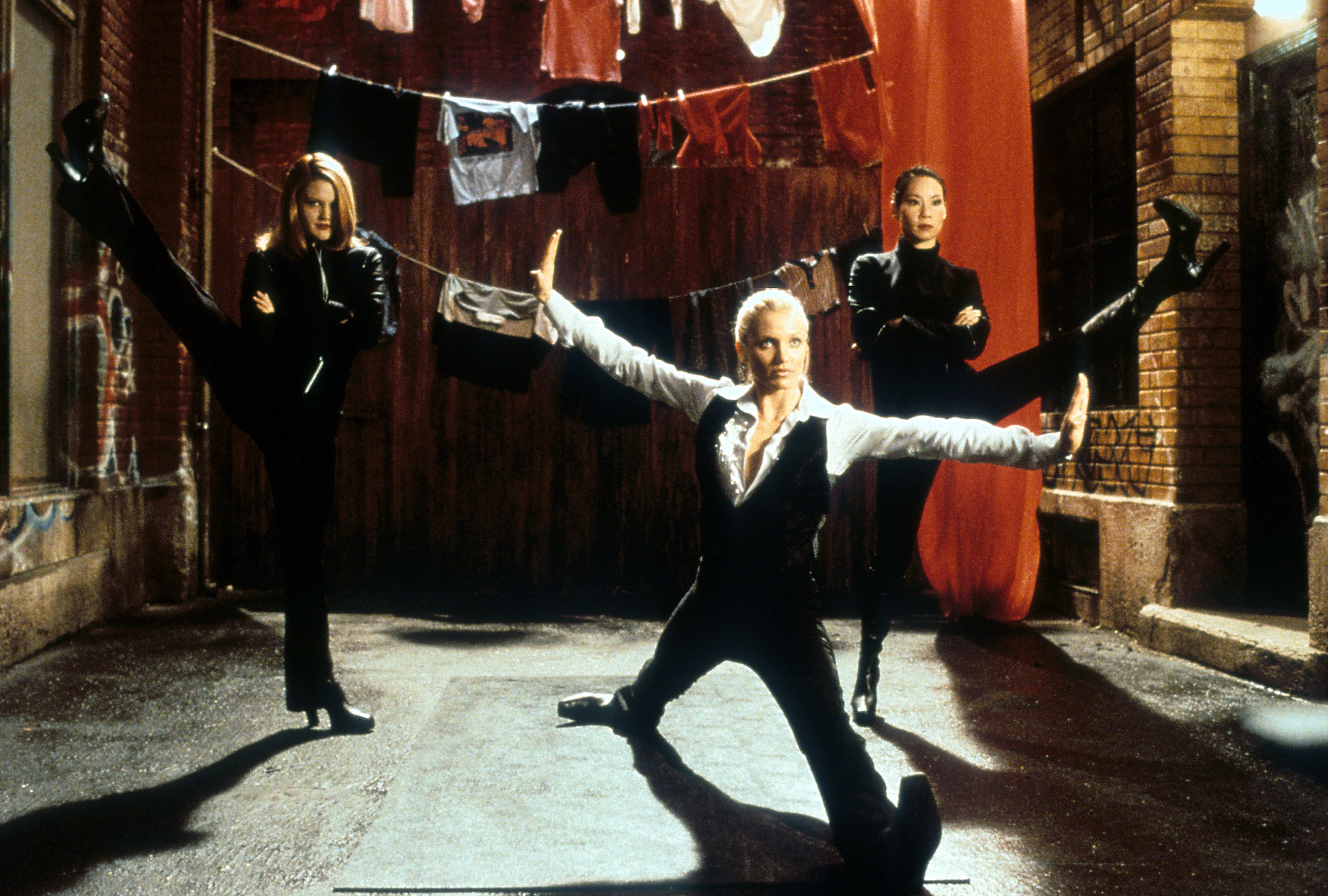 Cameron Diaz, Drew Barrymore, and Lucy Liu in a dynamic scene with high kicks.