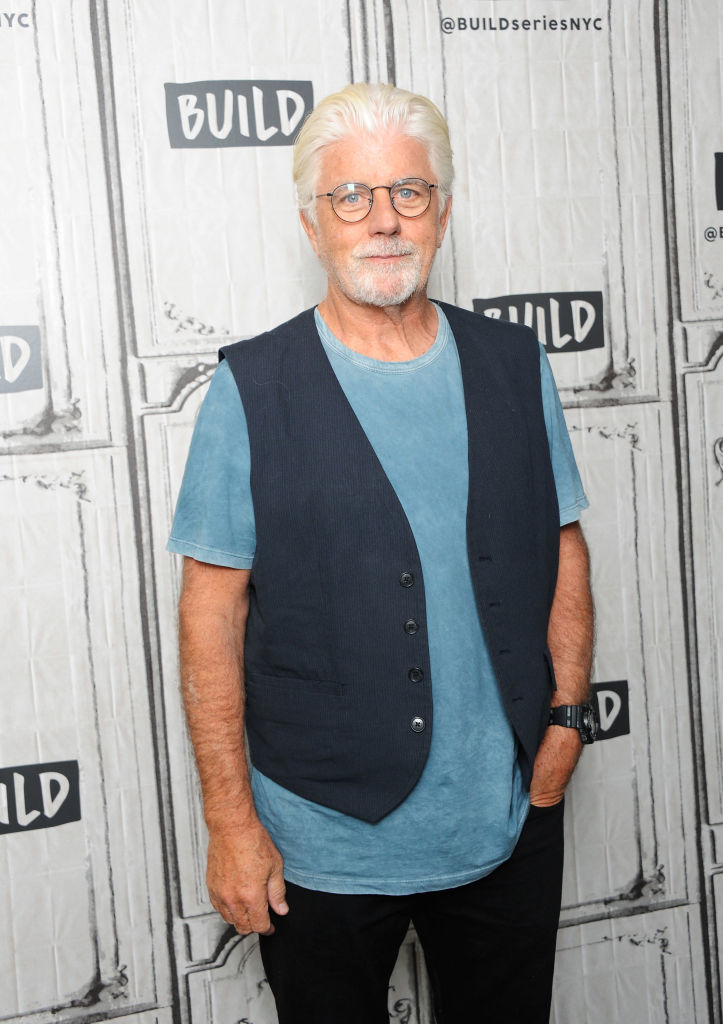 Michael McDonald in a casual outfit with a blue shirt and black vest, poses at Build Series NYC event