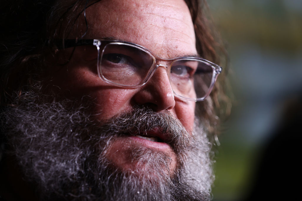 Jack Black with long hair and a full beard, wearing clear glasses, at a public event