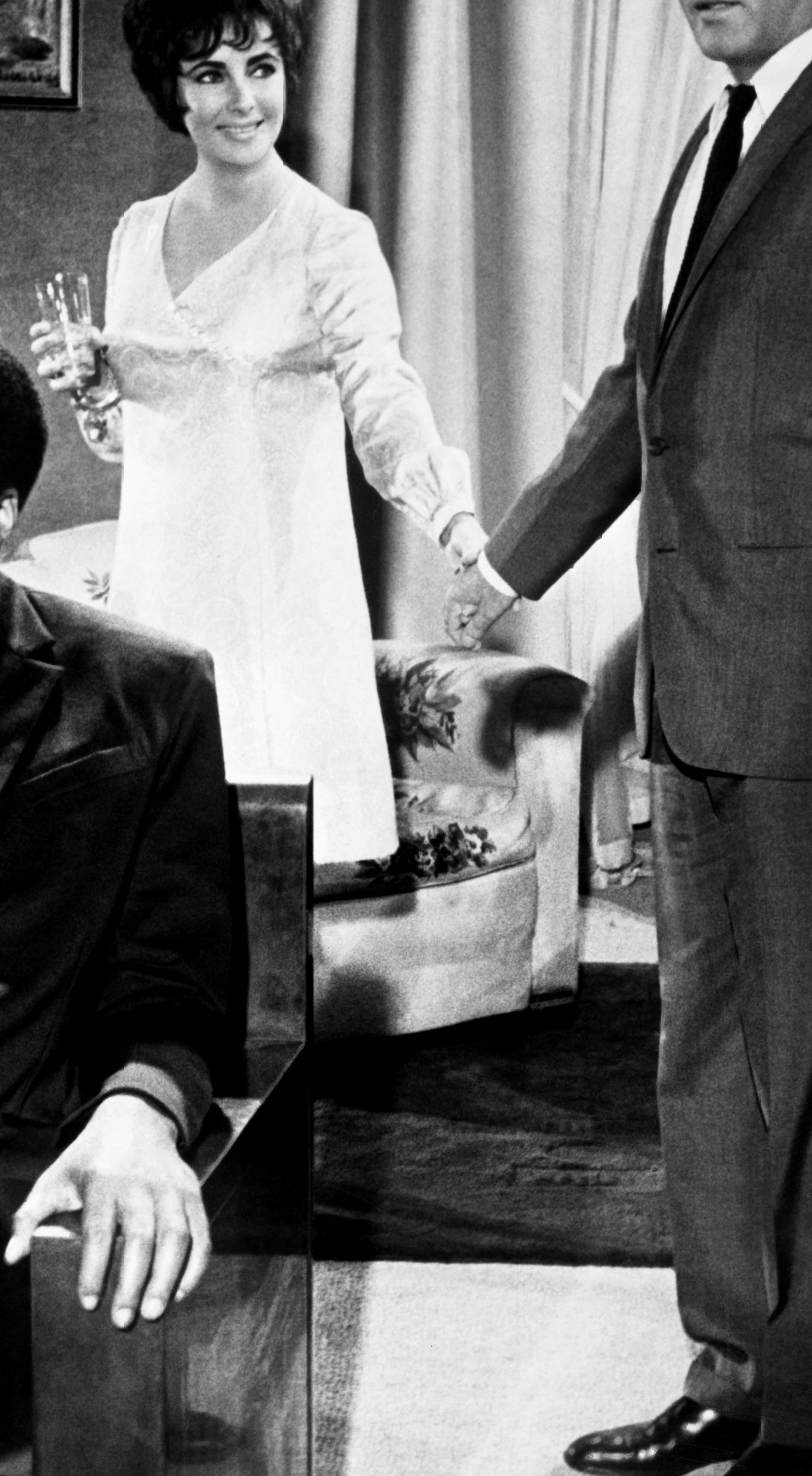 A young James Earl Jones in a suit tie sitting in a scene from 1967 film &quot;The Comedians&quot;