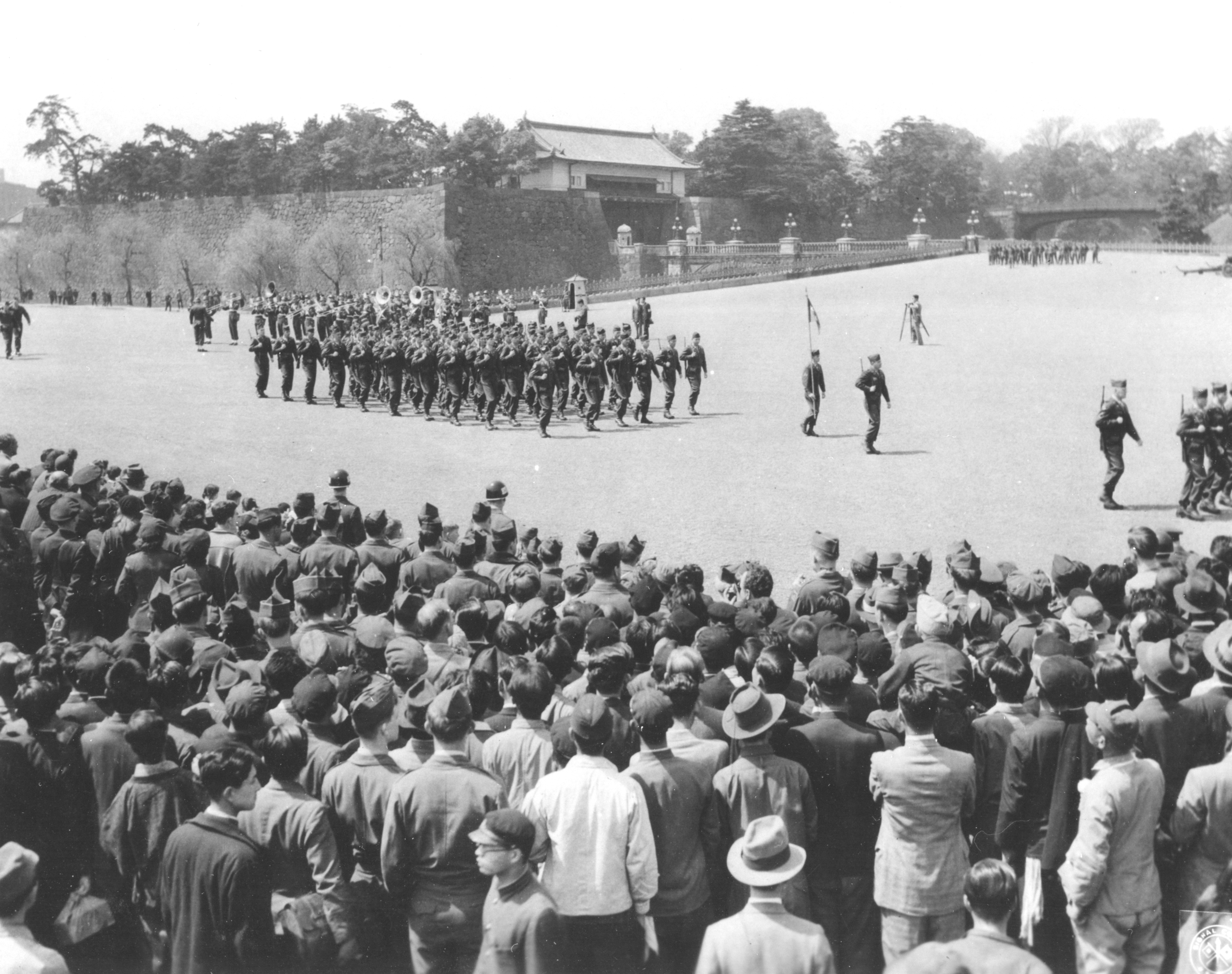 A historic view of American troops as they march past the reviewing stand during Army Day ceremony held at the Emperor's Palace Plaza grounds, Tokyo, Japan, April 6, 1948.